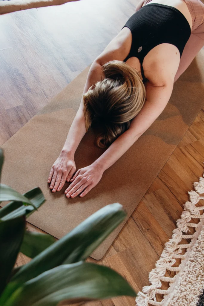 girl in child's pose, practicing yoga to handle a depressive episode