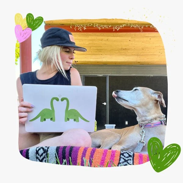 a girl with her dog behind the a laptop